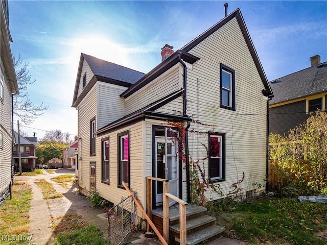 6114 W Clinton Ave, Cleveland, OH 44102 - rear view of house with a chimney