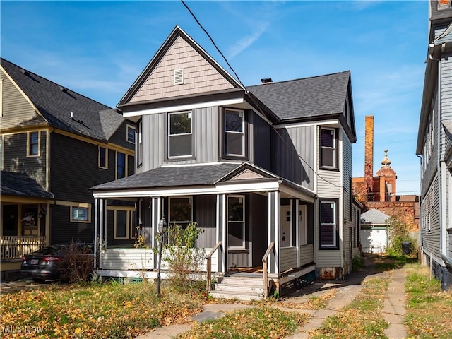 6114 W Clinton Ave, Cleveland, OH 44102 - view of front of house featuring board and batten siding, a porch, and a shingled roof
