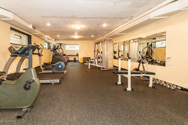 gym featuring a textured ceiling