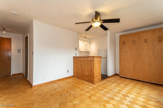 kitchen with ceiling fan, stainless steel fridge, and light parquet flooring