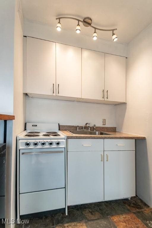 kitchen with sink, white cabinets, white range, and rail lighting