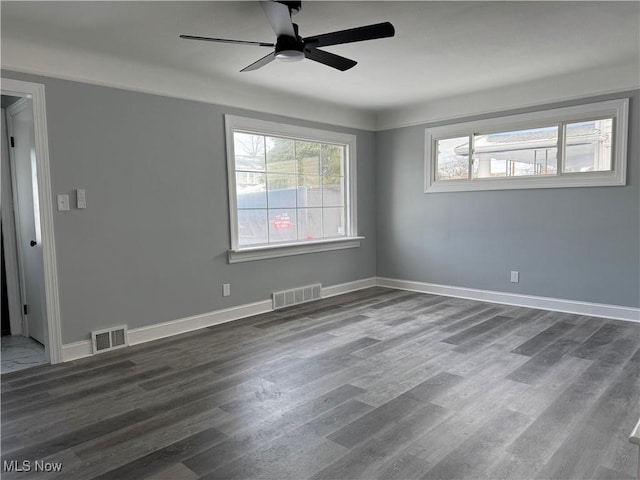 spare room featuring ceiling fan and dark hardwood / wood-style flooring