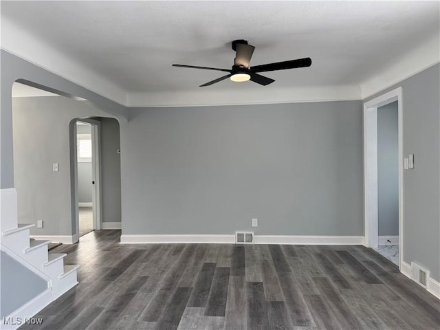 spare room featuring dark hardwood / wood-style floors and ceiling fan