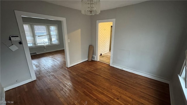 interior space featuring dark hardwood / wood-style floors and a chandelier