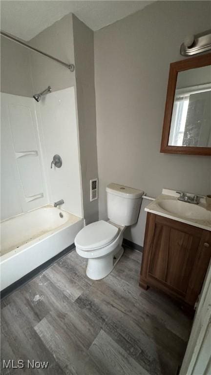 full bathroom featuring vanity, hardwood / wood-style flooring, toilet, and shower / bathtub combination