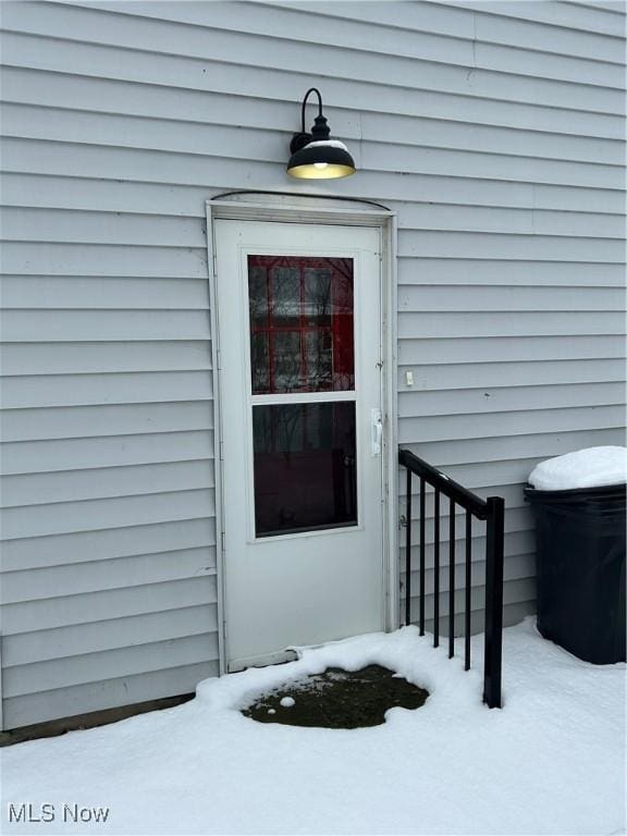 view of snow covered property entrance