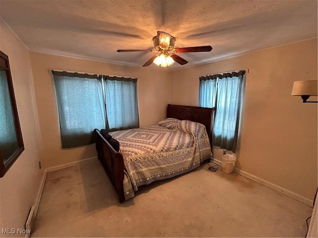 bedroom with a textured ceiling, carpet floors, and ceiling fan