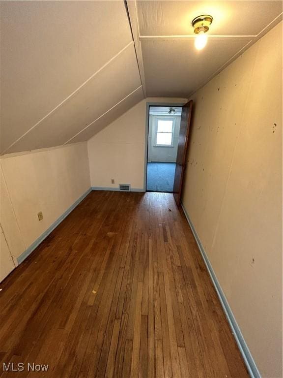 bonus room featuring lofted ceiling and hardwood / wood-style flooring