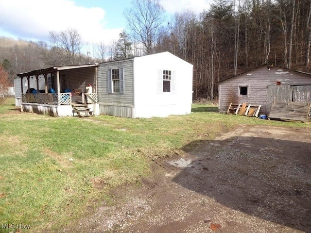 view of property exterior with a lawn and a porch