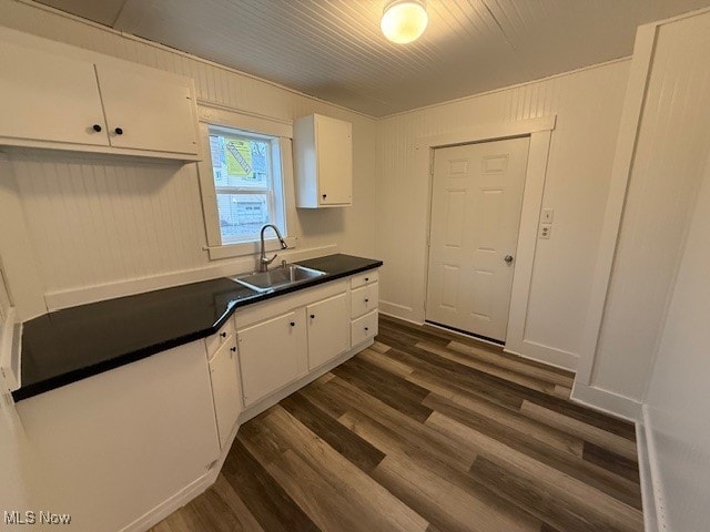 kitchen featuring white cabinets, dark hardwood / wood-style floors, and sink