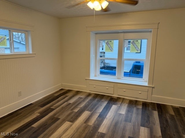 spare room featuring ceiling fan and dark hardwood / wood-style flooring