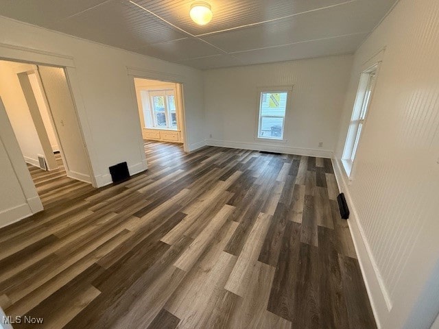 unfurnished room featuring dark hardwood / wood-style floors