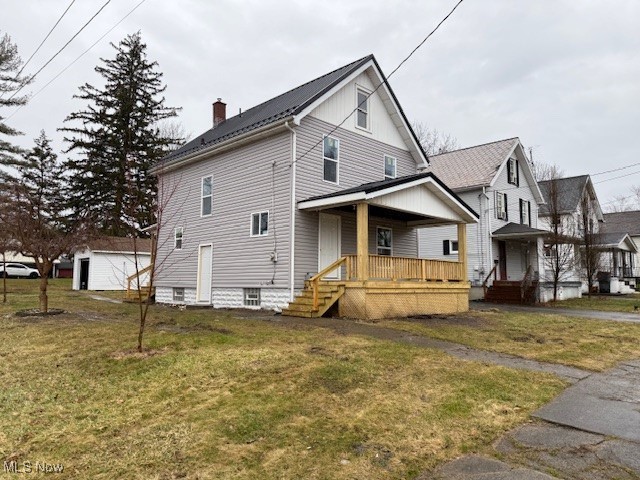 exterior space with covered porch and a yard