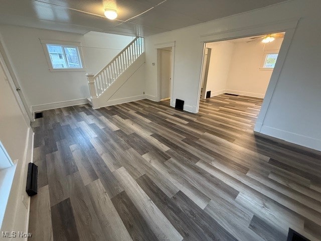 unfurnished living room with ceiling fan and dark hardwood / wood-style floors