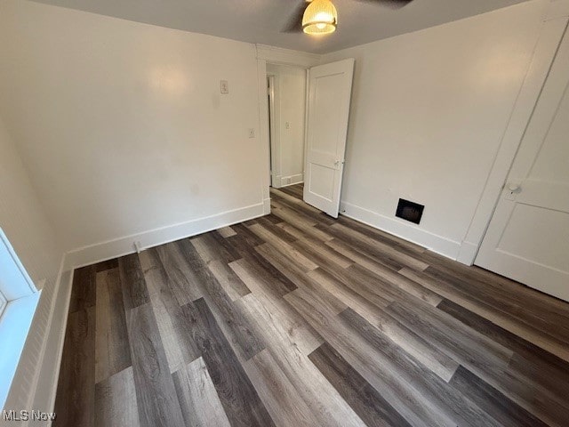 spare room with dark hardwood / wood-style floors