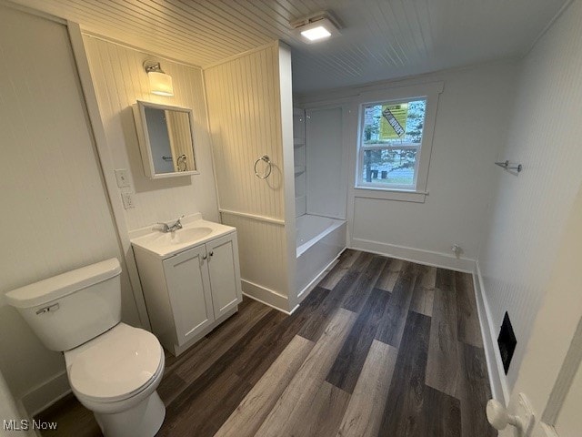 full bathroom featuring shower / bathing tub combination, hardwood / wood-style floors, vanity, and toilet