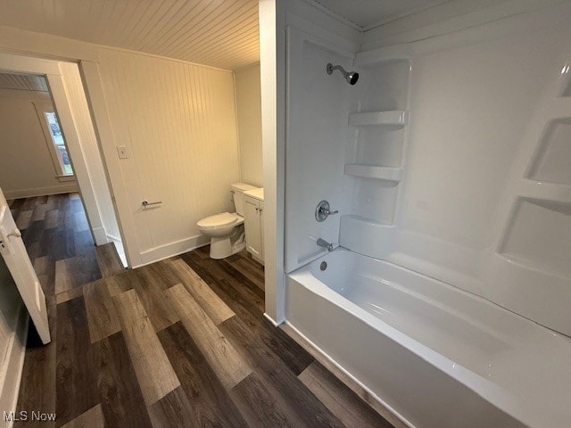 full bathroom with bathtub / shower combination, wood-type flooring, vanity, and toilet