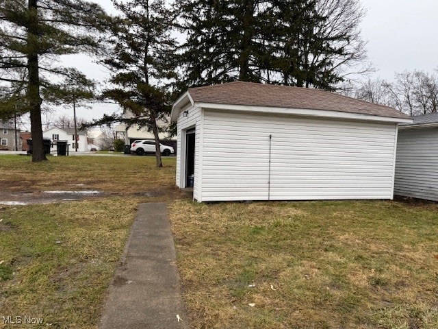 exterior space featuring a garage and a yard