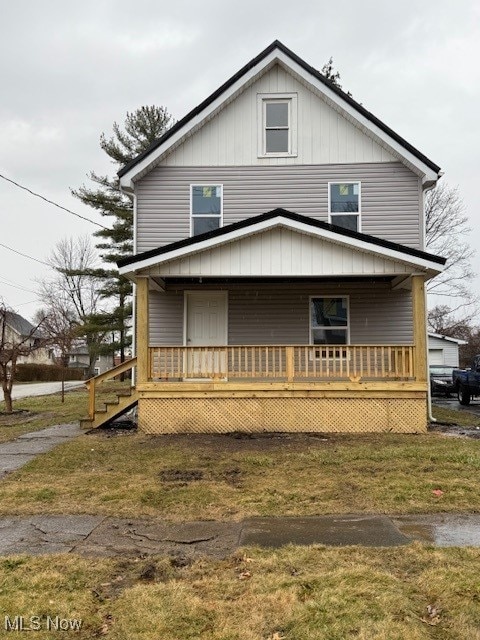 view of front of home featuring covered porch and a front yard