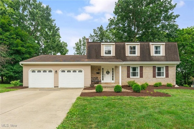 view of front of house with a front lawn and a garage