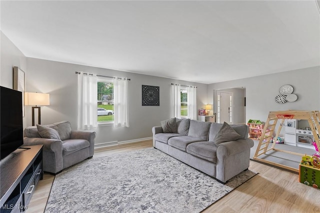 living room with plenty of natural light and light wood-type flooring