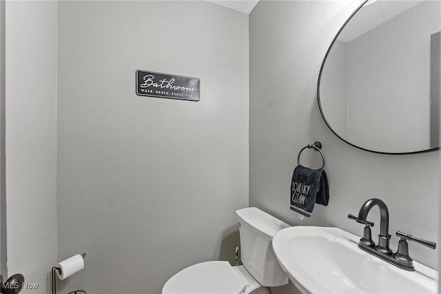 bathroom featuring toilet and sink