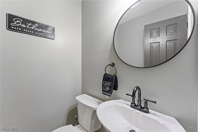 bathroom featuring toilet and sink