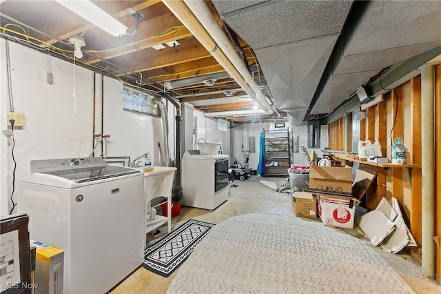 basement with separate washer and dryer and sink