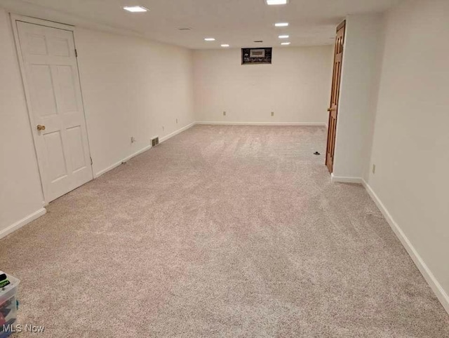 basement featuring light colored carpet