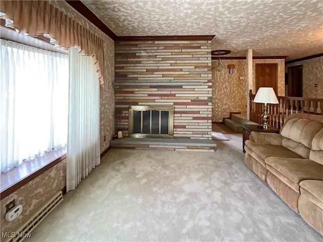 carpeted living room with a stone fireplace, ornamental molding, and a textured ceiling