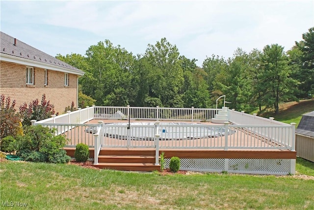 view of swimming pool with a yard and a wooden deck