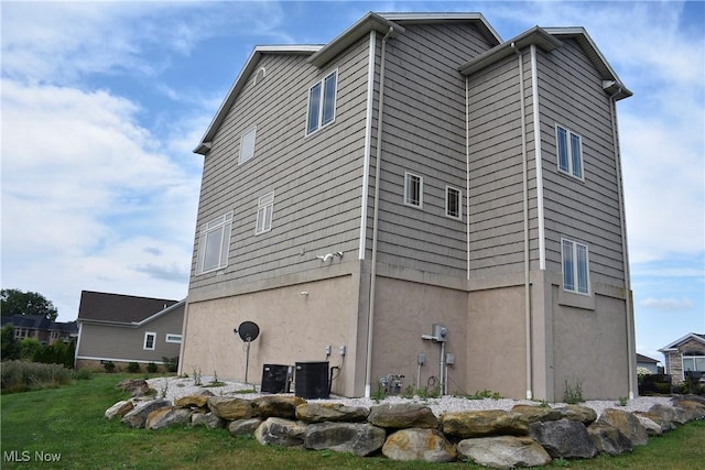 view of property exterior featuring a yard and central air condition unit