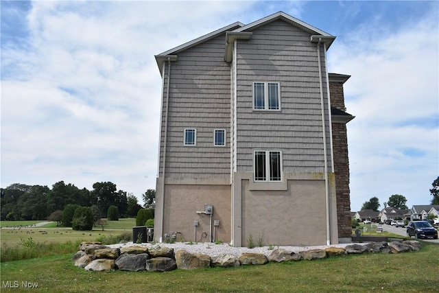 view of side of property with a yard