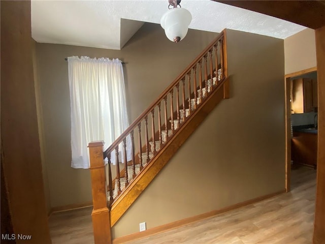 staircase featuring hardwood / wood-style floors