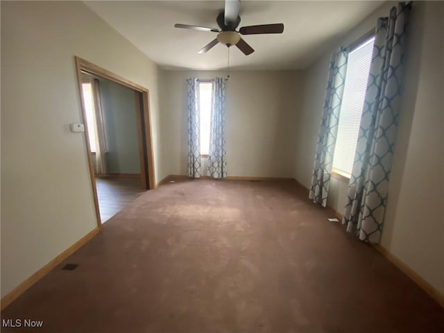 spare room with ceiling fan and light colored carpet