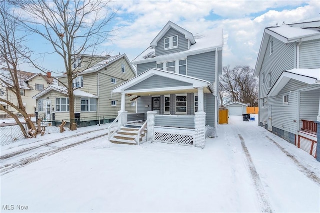 view of front of home featuring a porch and an outdoor structure