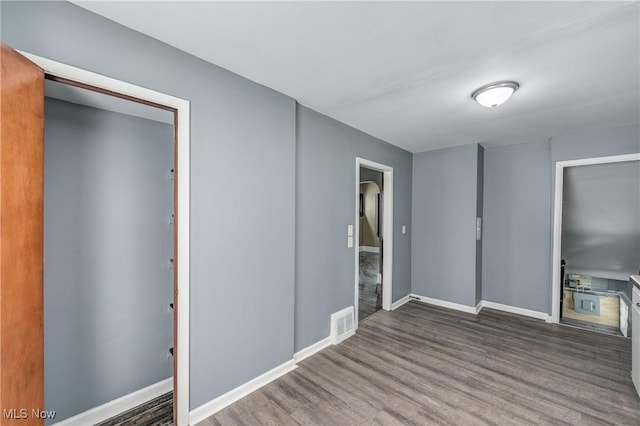 unfurnished bedroom featuring a closet and dark hardwood / wood-style flooring