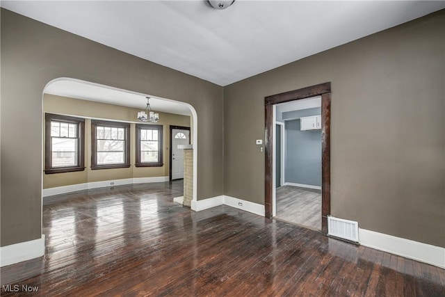 empty room with dark hardwood / wood-style floors