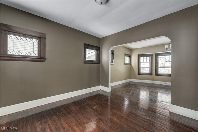 unfurnished room with dark wood-type flooring