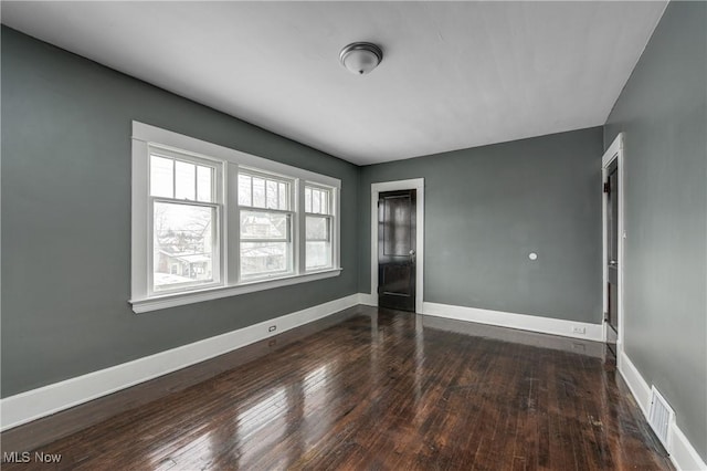 empty room featuring dark wood-type flooring