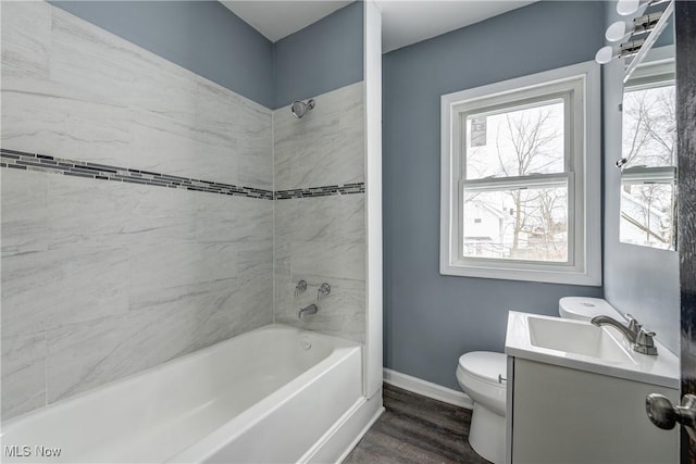 full bathroom with vanity, toilet, wood-type flooring, and tiled shower / bath combo