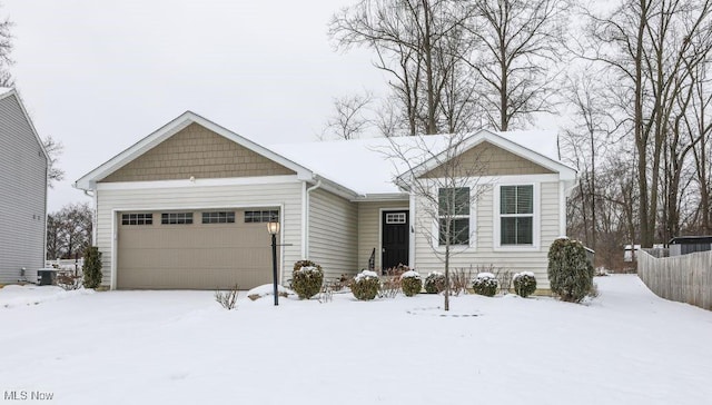 single story home featuring a garage and central AC