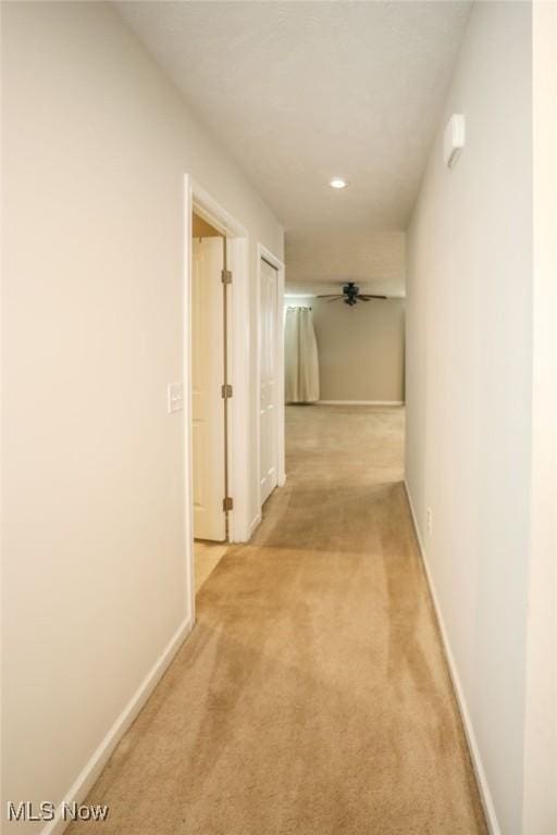 corridor with light colored carpet