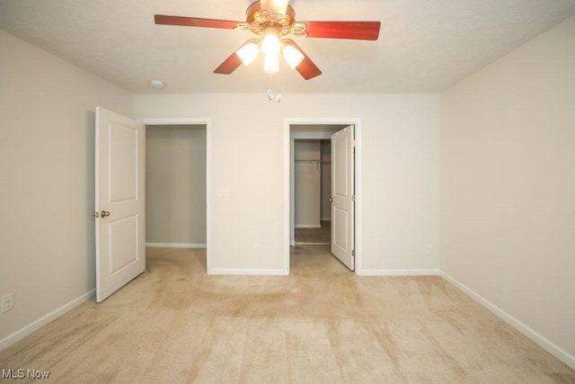 unfurnished bedroom with a closet, light colored carpet, and ceiling fan