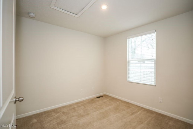 spare room featuring light colored carpet