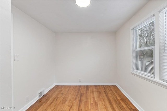 unfurnished room with wood-type flooring