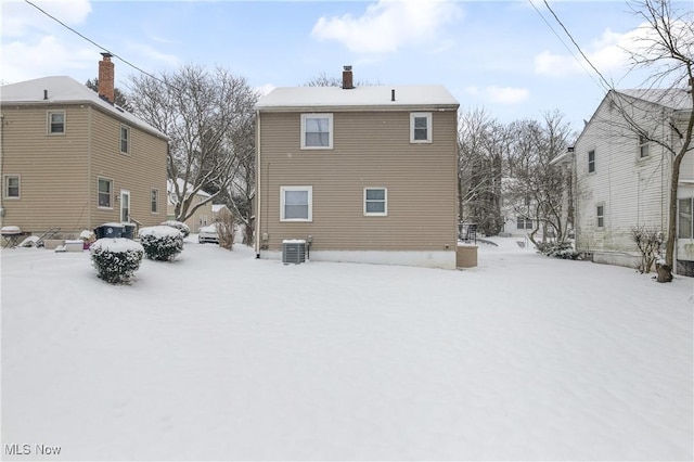 snow covered property featuring central air condition unit