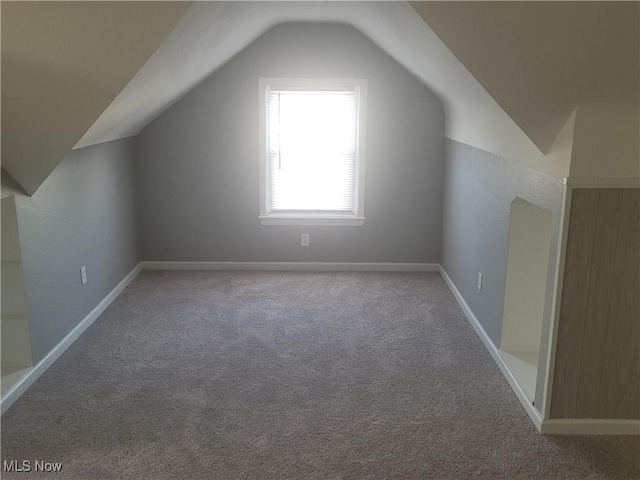 bonus room featuring carpet flooring and vaulted ceiling