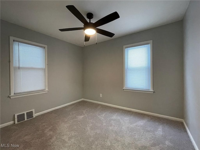 carpeted empty room featuring ceiling fan