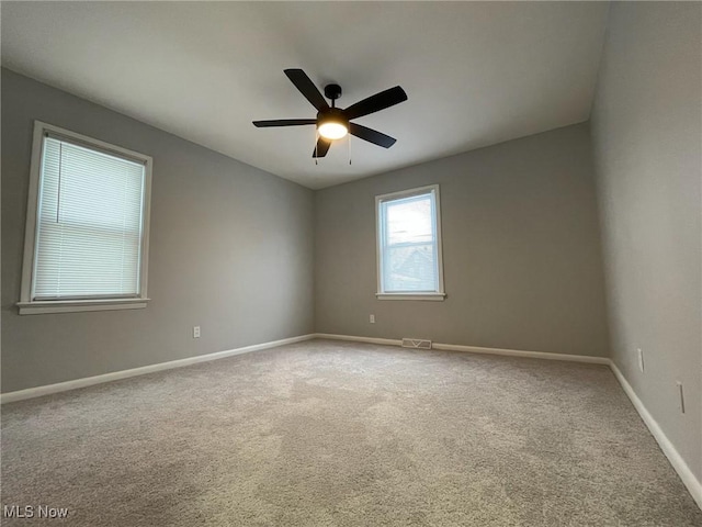 carpeted empty room featuring ceiling fan